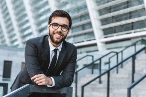 Portrait Of A Young Man Businessman With Eyeglasses Against The